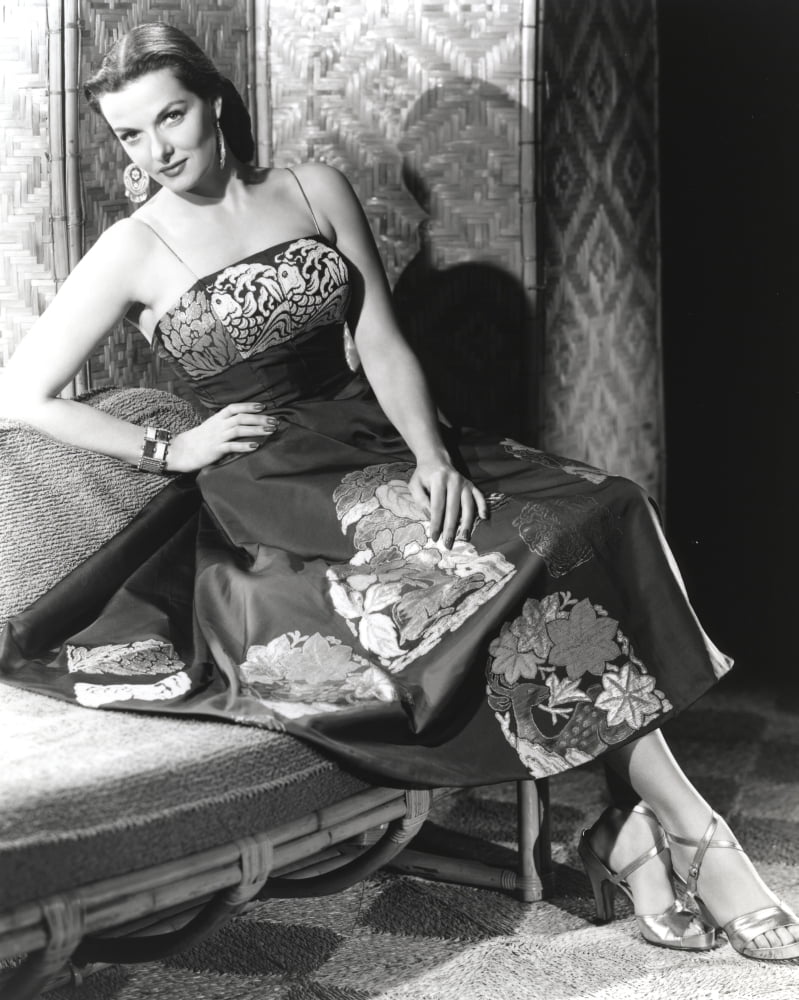 Jane Russell seated in a silk floral strap dress photo print.