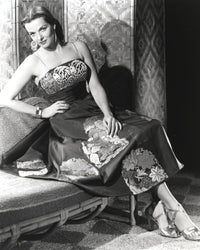 Jane Russell seated in a silk floral strap dress photo print.
