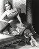 Jane Russell seated in a silk floral strap dress photo print.