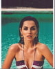 Ana De Armas lounging in a pool wearing a striped halter top photo print.