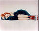 Geri Halliwell Laying in Blue Fur Photo Print showcasing elegance and charm.