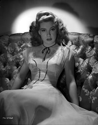 Gloria DeHaven Black and White Photo Print sitting on couch in gown.