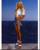 Pamela Anderson photo print in ripped denim shorts and heels.