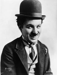 Charlie Chaplin smiling in coat and tie photo print