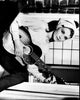 Audrey Hepburn playing guitar on a windowsill - Breakfast at Tiffany's black and white photo print