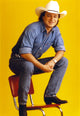 Mark Chesnutt cowboy photo print sitting in a chair wearing cowboy outfit