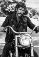 Sam Elliott riding a motorbike photo print in vibrant colors.