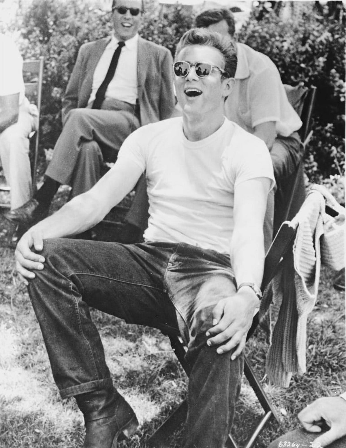 James Dean seated in a white round neck t-shirt photo print.