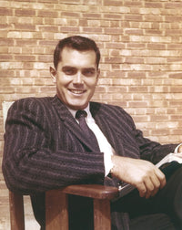 Jeffrey Hunter seated in striped suit photo print, classic Hollywood style.