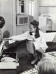 Audrey Hepburn film still photo print wearing an eye mask and packing a suitcase.