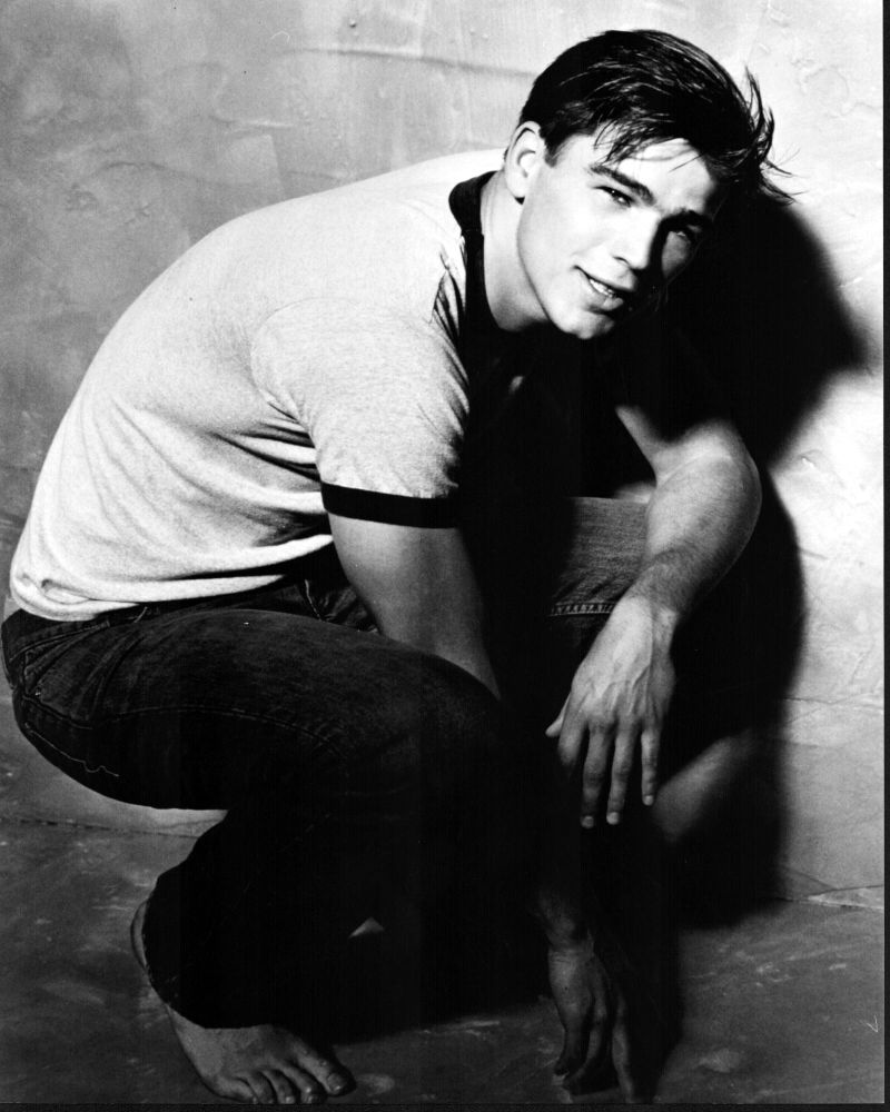 Black and white photo print of Josh Hartnett crouching in jeans