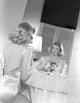 Gloria Grahame looking in a mirror wearing a backless dress photo print