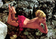 Elke Sommer laying face down on rocks topless with red bottoms photo print.