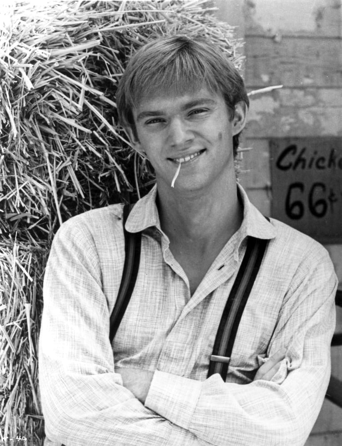 Richard Thomas wearing suspenders in front of a hay bale photo print