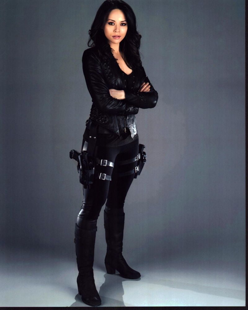 Melissa O'Neil Dark Matter photo print featuring a character in a black outfit with thigh gun holsters.