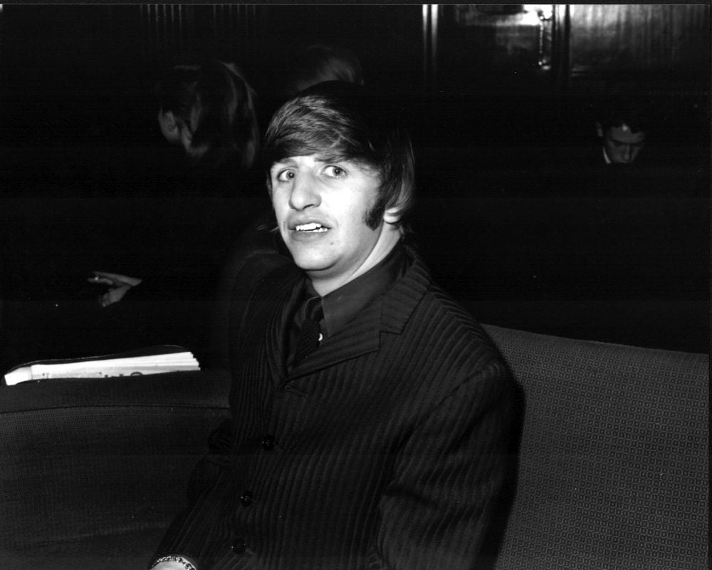 Black and white photo print of Ringo Starr in a striped suit.