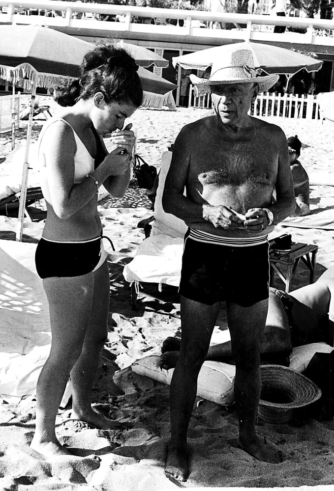 Pablo Picasso and Jacqueline Roque at the beach photo print