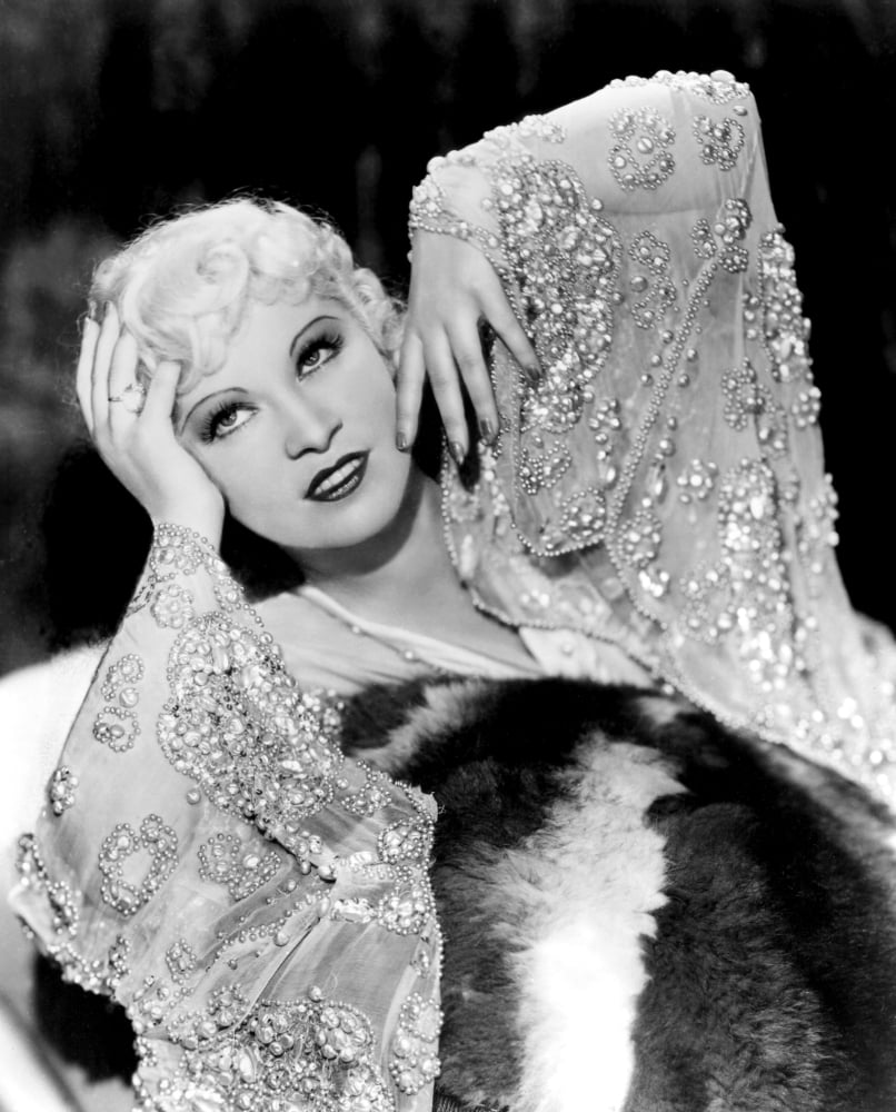 Mae West vintage photo print in beaded dress on a fur rug from the 1930s.