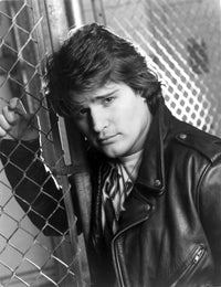 Peter Deluise photo print wearing a leather jacket leaning on a wire fence.