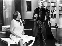 Rosalind Russell classic photo print in dress with woman seated on chair.