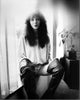 Kate Bush sitting on a windowsill in leather boots photo print.