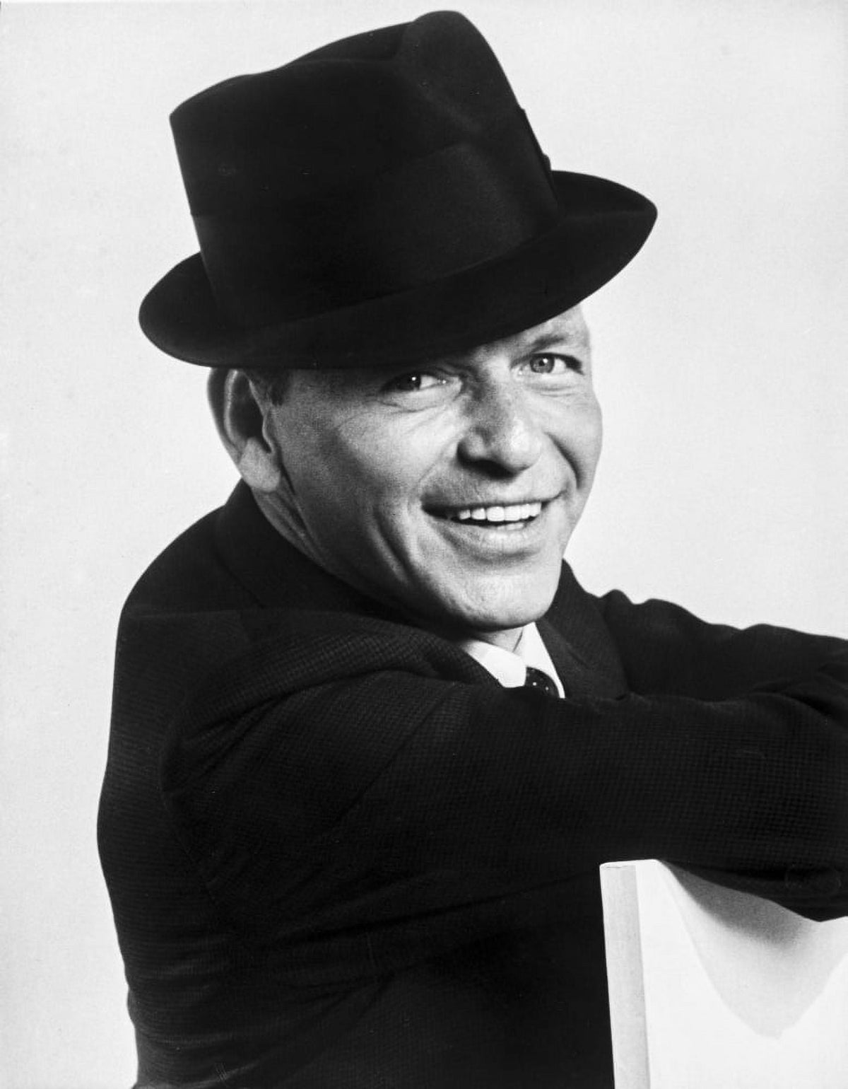 Frank Sinatra smiling photo print in suit and black hat.