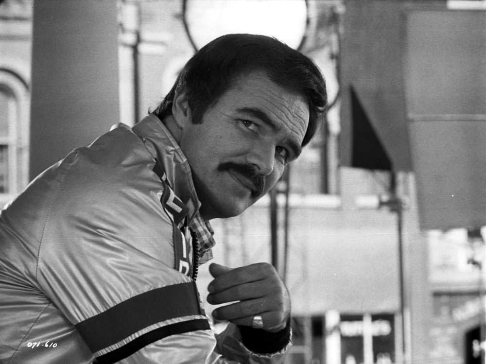 Burt Reynolds wearing a metallic jacket photo print