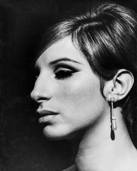 Close-up portrait photo print of Barbra Streisand with hook earrings on black background.