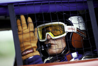 Paul Newman wearing a helmet and goggles in a racing car photo print.