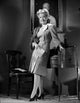 Gloria DeHaven leaning on a table in a formal dress - black and white photo print.
