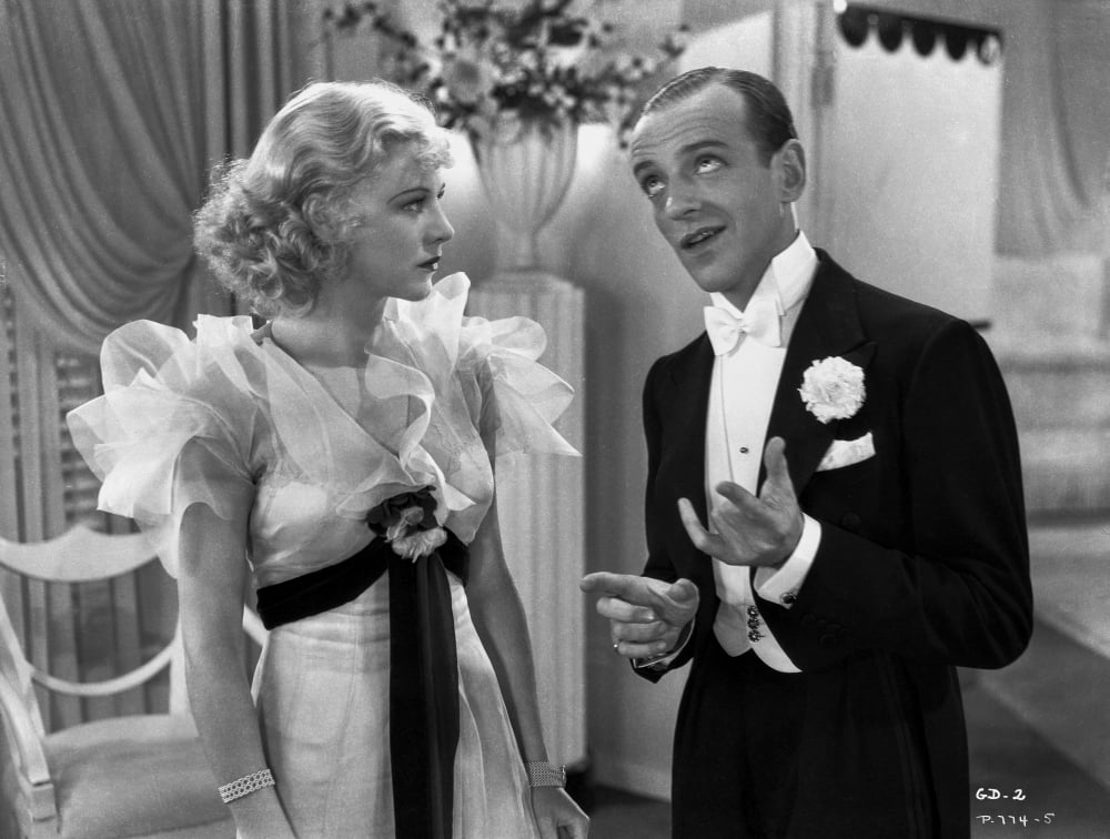 Fred Astaire and Ginger Rogers conversing in classic photo print.