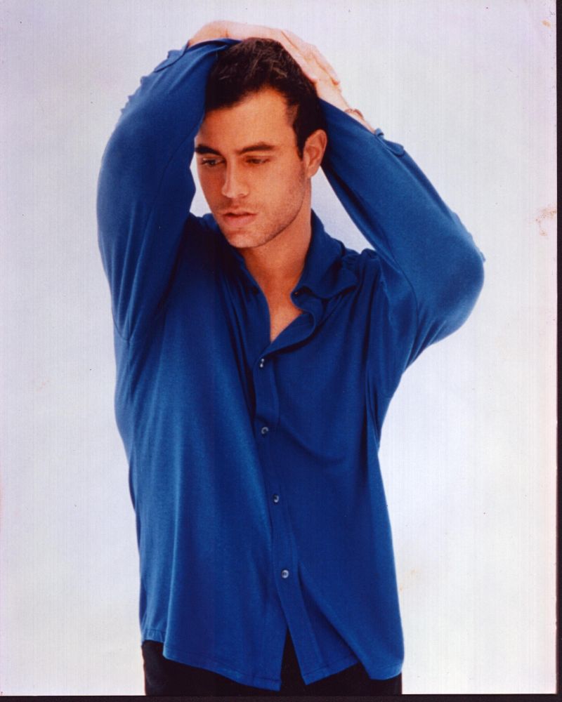 Enrique Iglesias photo print in blue top with arms raised.