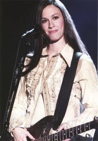 Alanis Morissette playing guitar in a stylish coat photo print.