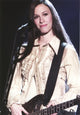 Alanis Morissette playing guitar in a stylish coat photo print.