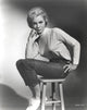 Janet Leigh seated in a white high neck linen dress photo print