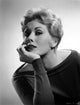 Kim Novak leaning photo print showcasing classic film elegance.
