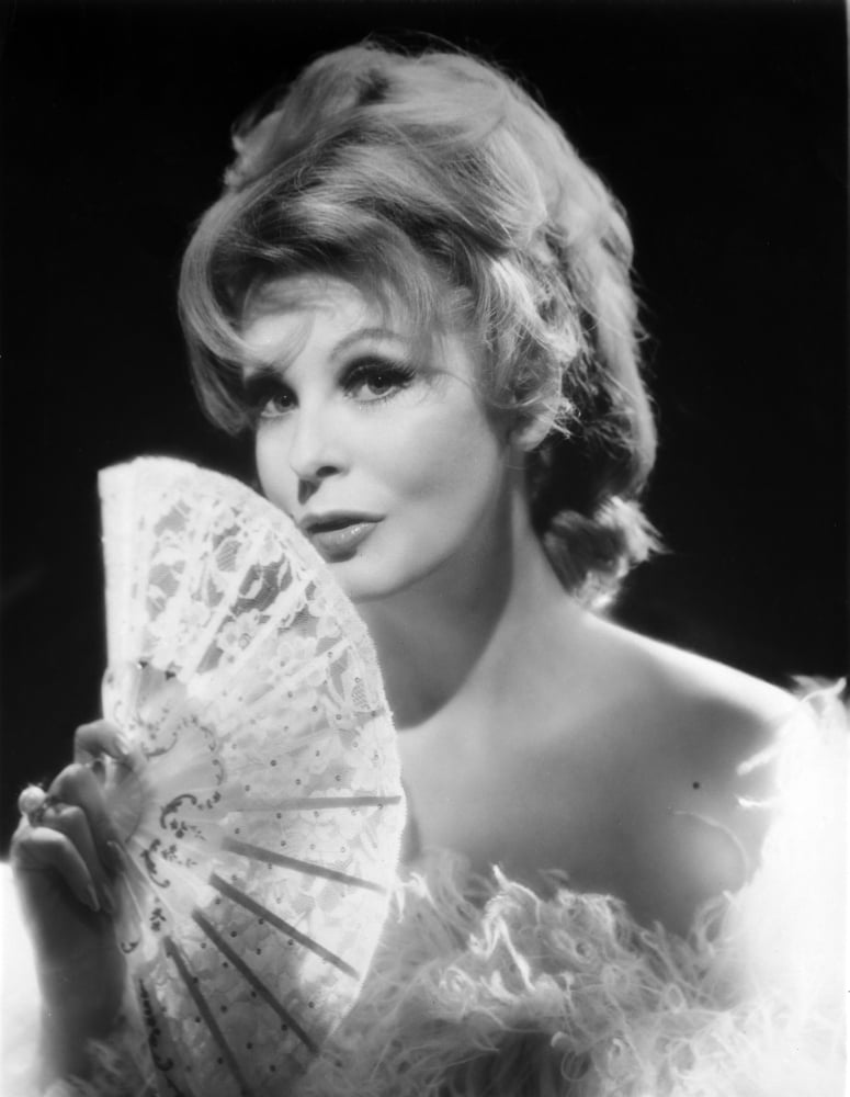 Arlene Dahl posed in a furry dress holding a fan photo print