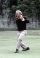Arnold Palmer playing golf photo print, perfect for golf enthusiasts.