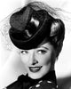 Eleanor Parker modeling a felt hat with black satin trim in October 1943 photo print.