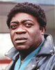 Yaphet Kotto close-up portrait photo print showing actor in a black jacket.