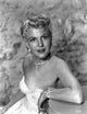 Peggy Lee seated in white gown with pearl necklace portrait photo print