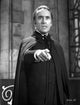 Film still photo print of Christopher Lee as Dracula pointing.