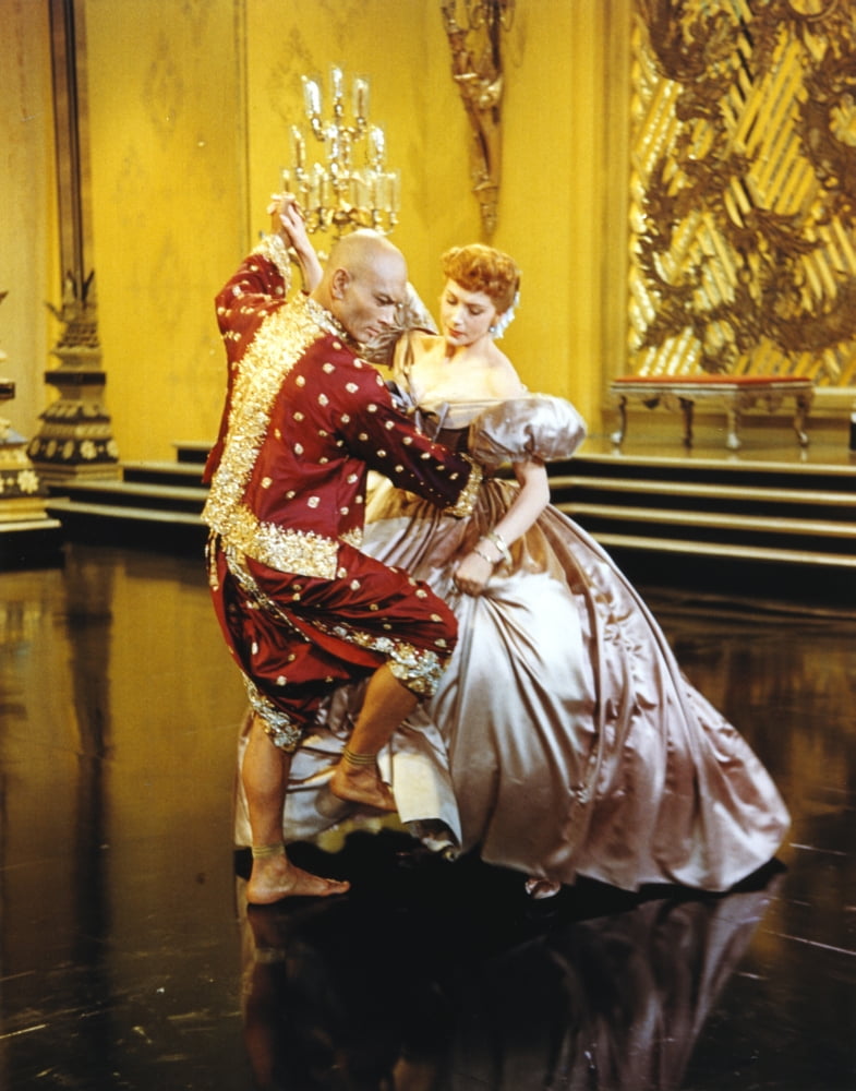 Yul Brynner dancing with a lady in shiny dress photo print.