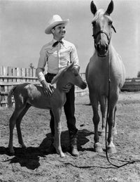 Gene Autry smiling with a horse and pony photo print.