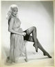 Mamie Van Doren photo print with leg up in black stockings