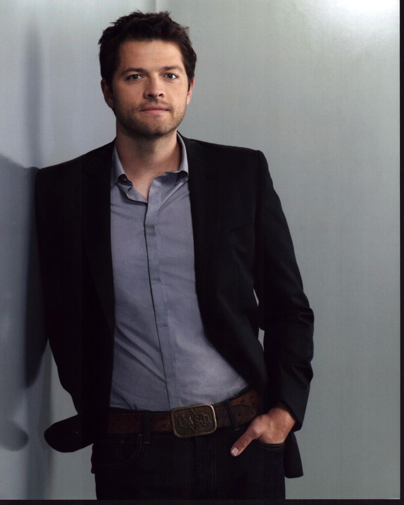 Misha Collins leaning against a wall with hand in pocket photo print