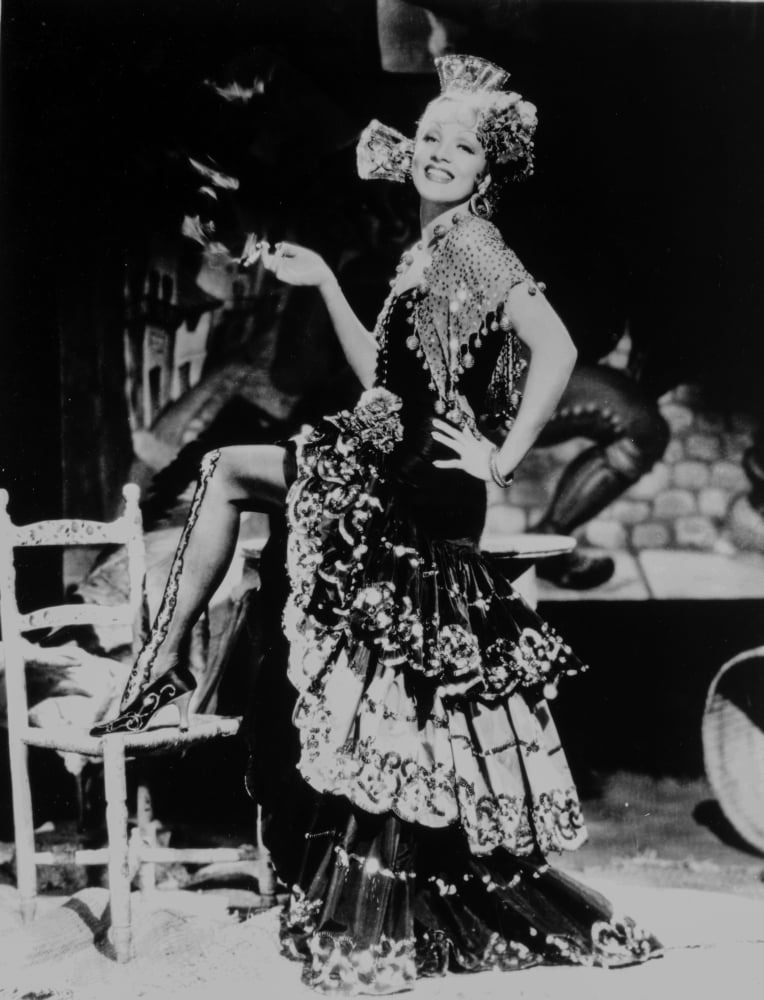 Marlene Dietrich standing on one leg in floral gown photo print