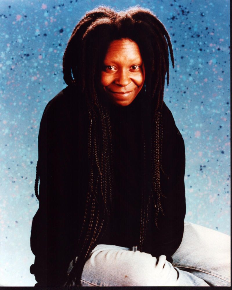 Whoopi Goldberg sitting in jeans with splatter background photo print