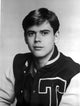 Photo print of Thomas Howell wearing a varsity jacket.