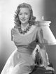 Gloria Grahame posed elegantly in a sexy dress with a large necklace photo print.